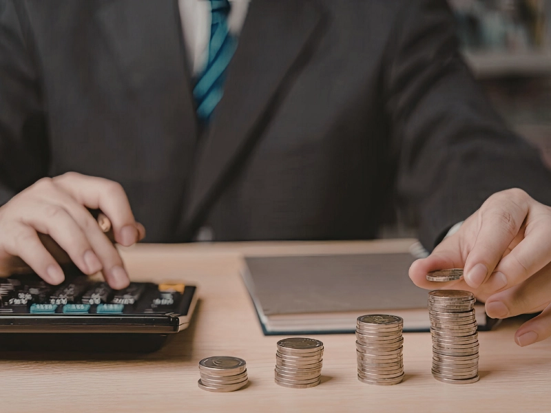 person building emergency fund on tight budget by counting and saving money at home